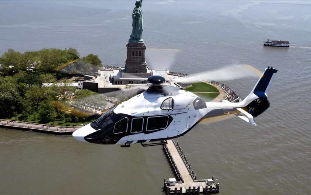 Airbus H160 flying by Statue of Liberty